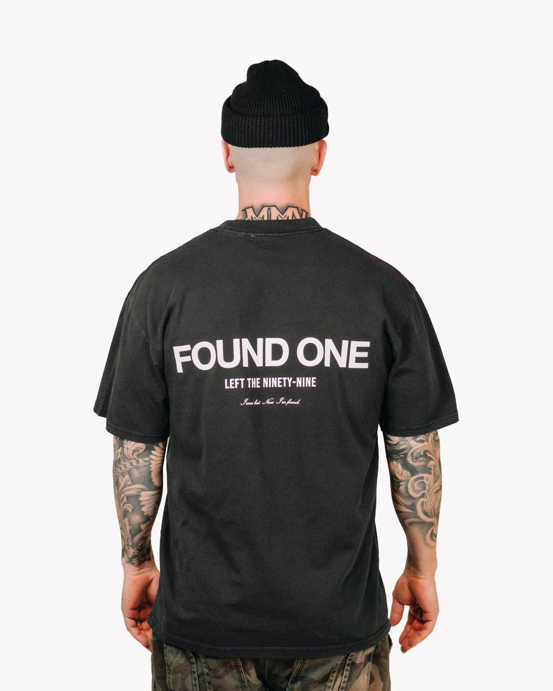 Model wearing the Found One Statement T-Shirt in Faded Black, a relaxed-fit Christian tee with Found One design on the back.